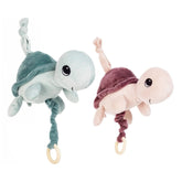 Two turtle plush carillons in pastel green and pink, each with friendly faces and pull rings for soothing melodies.